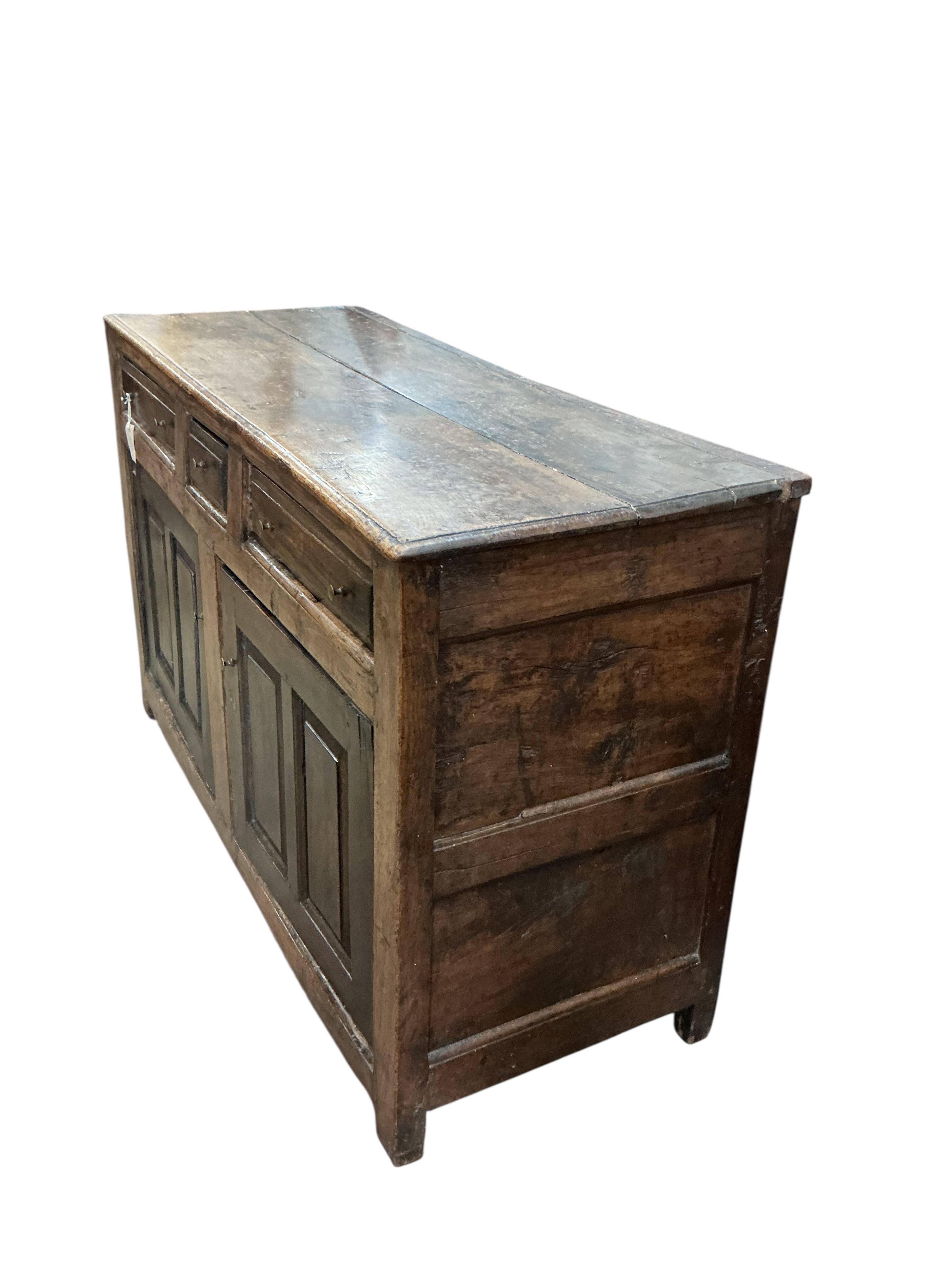 A mid 18th century North Wales oak enclosed dresser base, width 134cm, depth 52cm, height 85cm